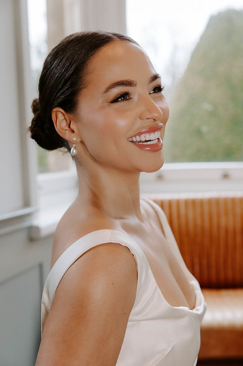 bride with hair in a bun laughing.jpeg