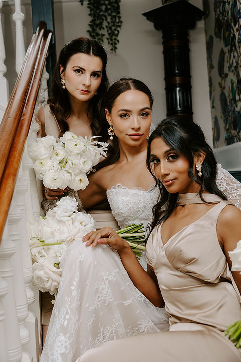 bride and bridesmaids on stairs.jpeg