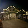 Custom outdoor Christmas lights shining on a residential property in Kelowna.