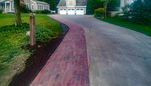 Reclaimed brick walkway and stone hitching post