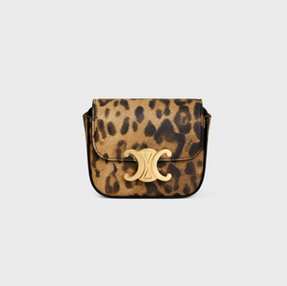 A cheetah print purse with a gold embellishment