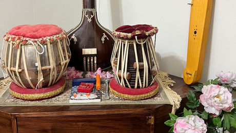 Kantele, tabla drums, tanpura, and musical altar setup with flowers, created for the AOS Perspectives Blog post "Music: Kantele and the Lifelong Bond of Sound".