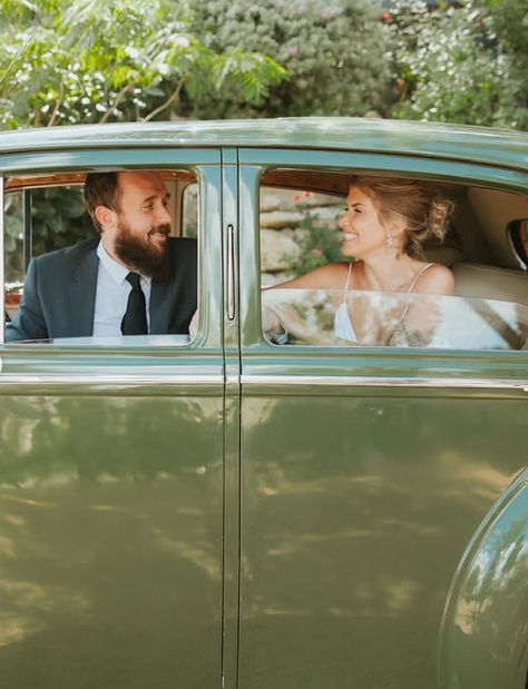 bride and groom in green classic car