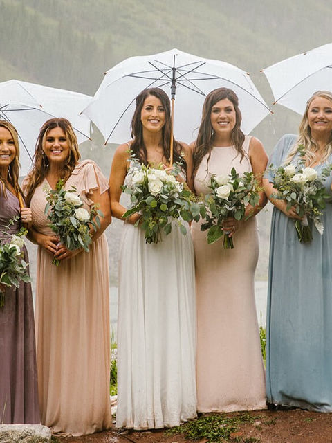 White, silver, and green bridal party bouquets in the rain