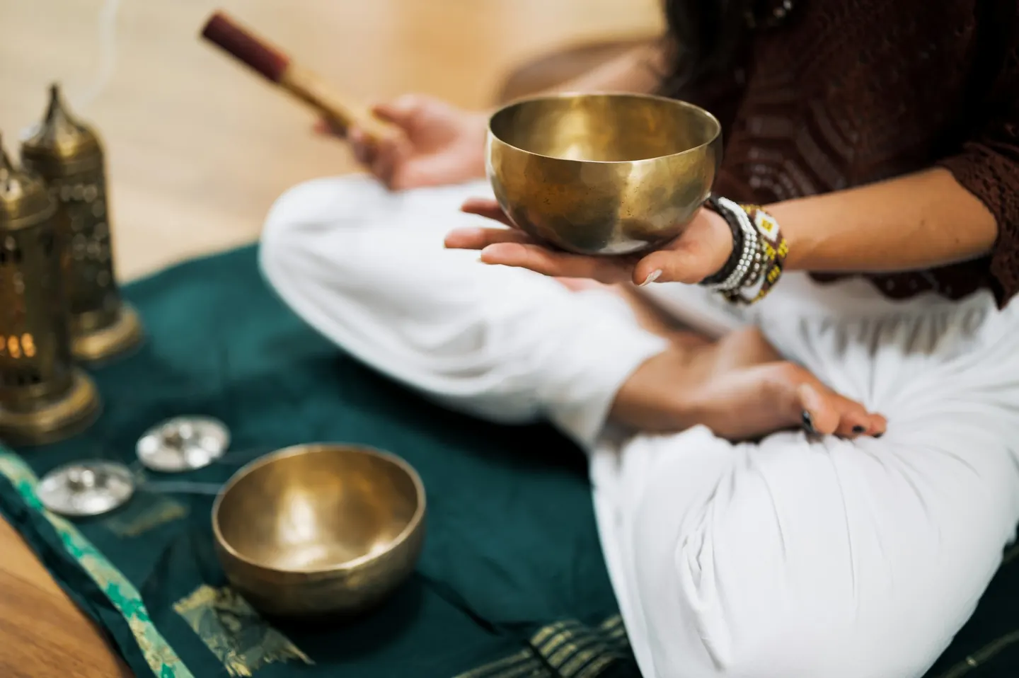 Hands holding a brass singing bowl