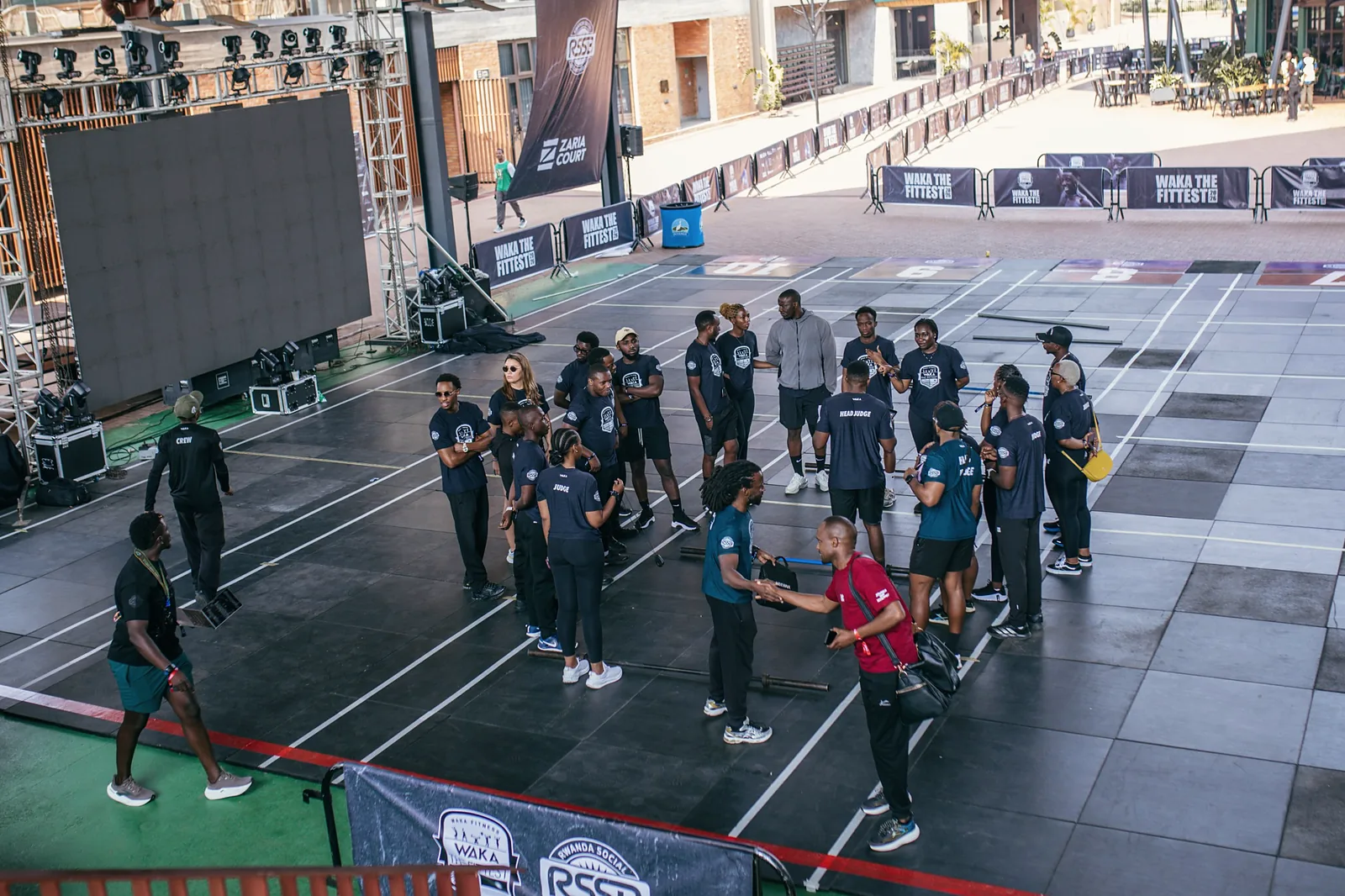 Overhead view of the competition floor with marked lanes, stage lighting and equipment cases