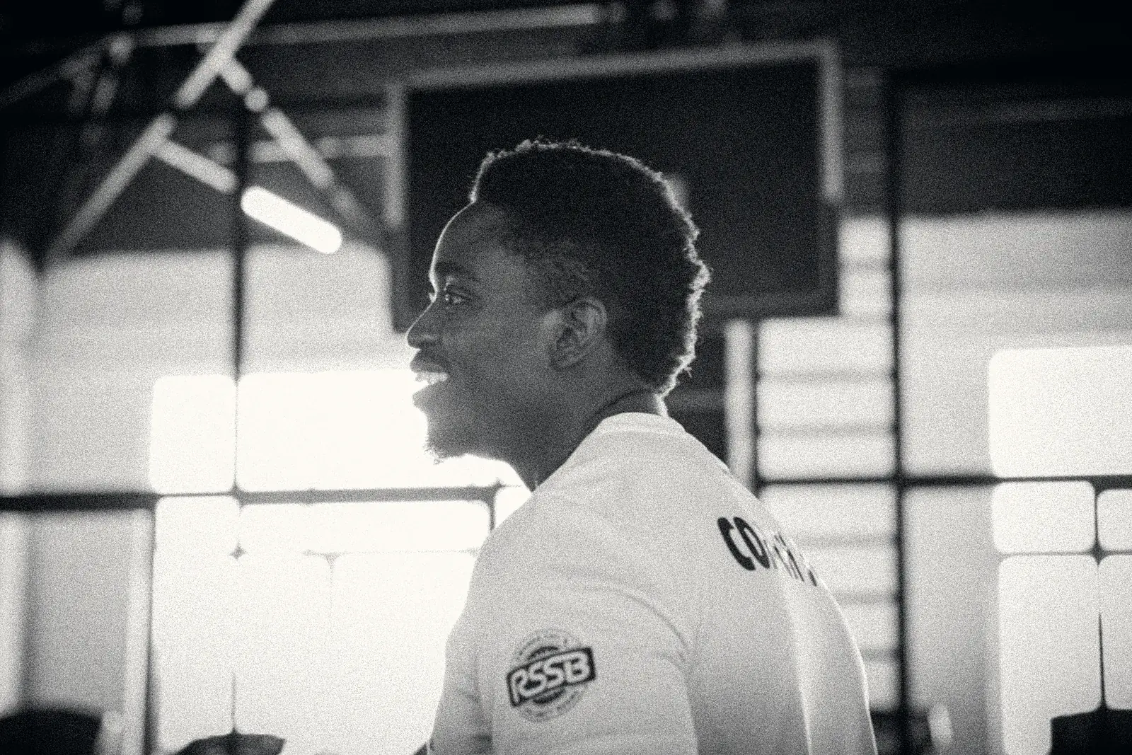 Coach smiling as he watches a training session