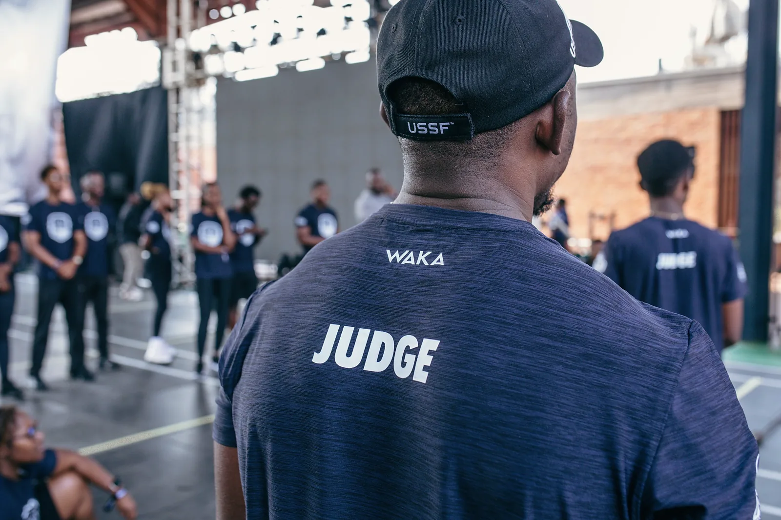 Judge in an event shirt watching over the competition floor