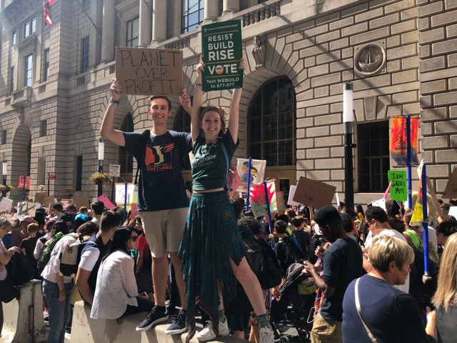 EcoReps Matt and Ashlyn raise their signs high at the NYC Climate Strike 2019