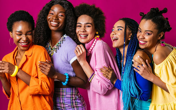 Group of Black women standing close together and laughing, representing joy, connection, and community
