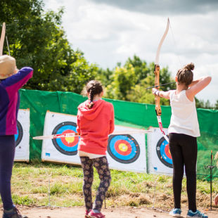 3 women shooting bows at archery targets