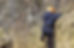A person climbing up a rock face.