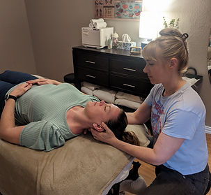Leah sitting down massaging patient