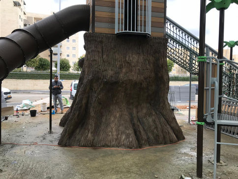 מתקן גלישה לילדים מותקן על עיצוב של גזע עץ