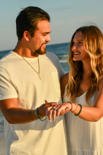 Couple embracing after a surprise proposal during a photo session in Panama City Beach