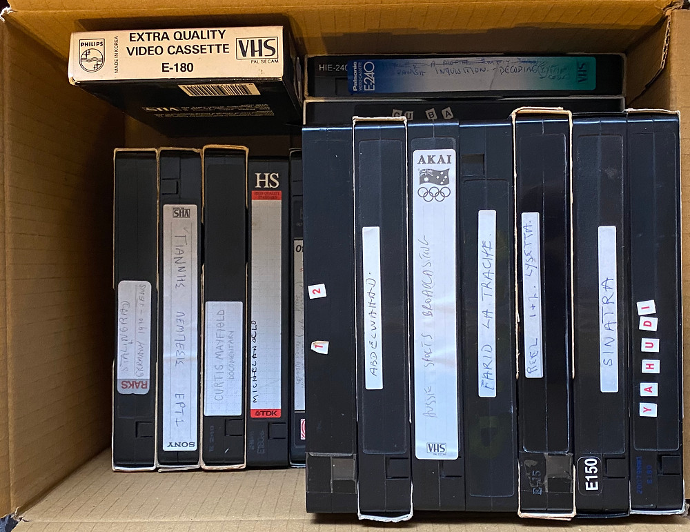 Some are junk and some contain treasure, like my brother playing on TV, So they all get boxed up to be stored.