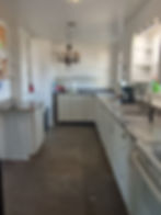 Bright, modernized kitchen space offering abundant storage and meal prep room.