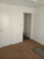 Convenient rear utility and laundry room entrance prioritizing home functionality.