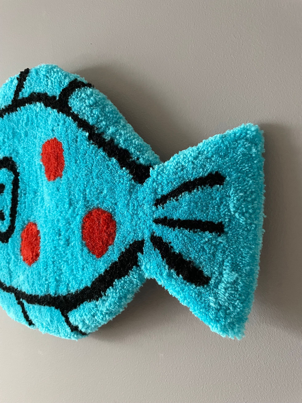 Thumbnail: Hand-tufted ‘Happy Plaice’ rug with vibrant red spots on turquoise, shaped like a playful fish.