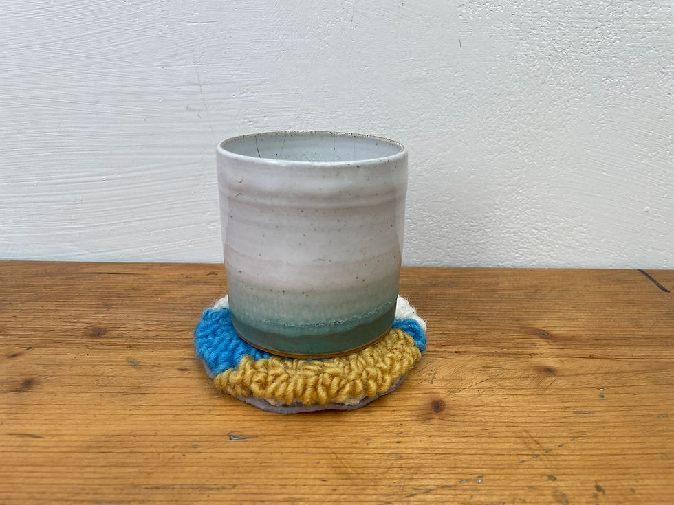 Thumbnail: Handmade wool coaster with turquoise sea and golden sand design.