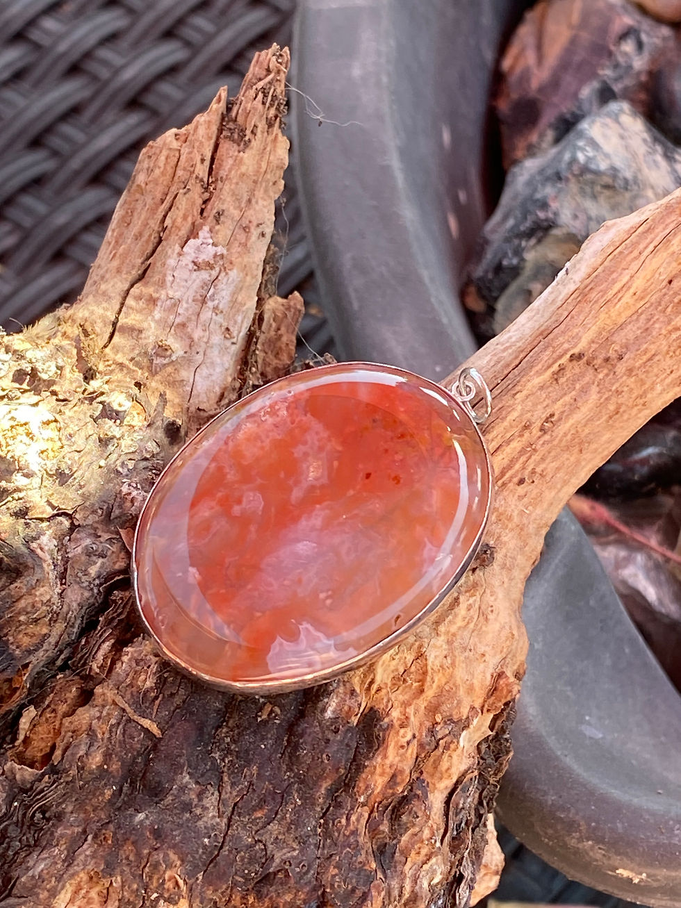 Close-up of Bubblegum Agate showing unique pink and red swirls in its sterling silver setting.