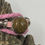 Thumbnail: Close-up of Butte Creek Agate stone on a pink leather bracelet, displayed against a tree bark background.