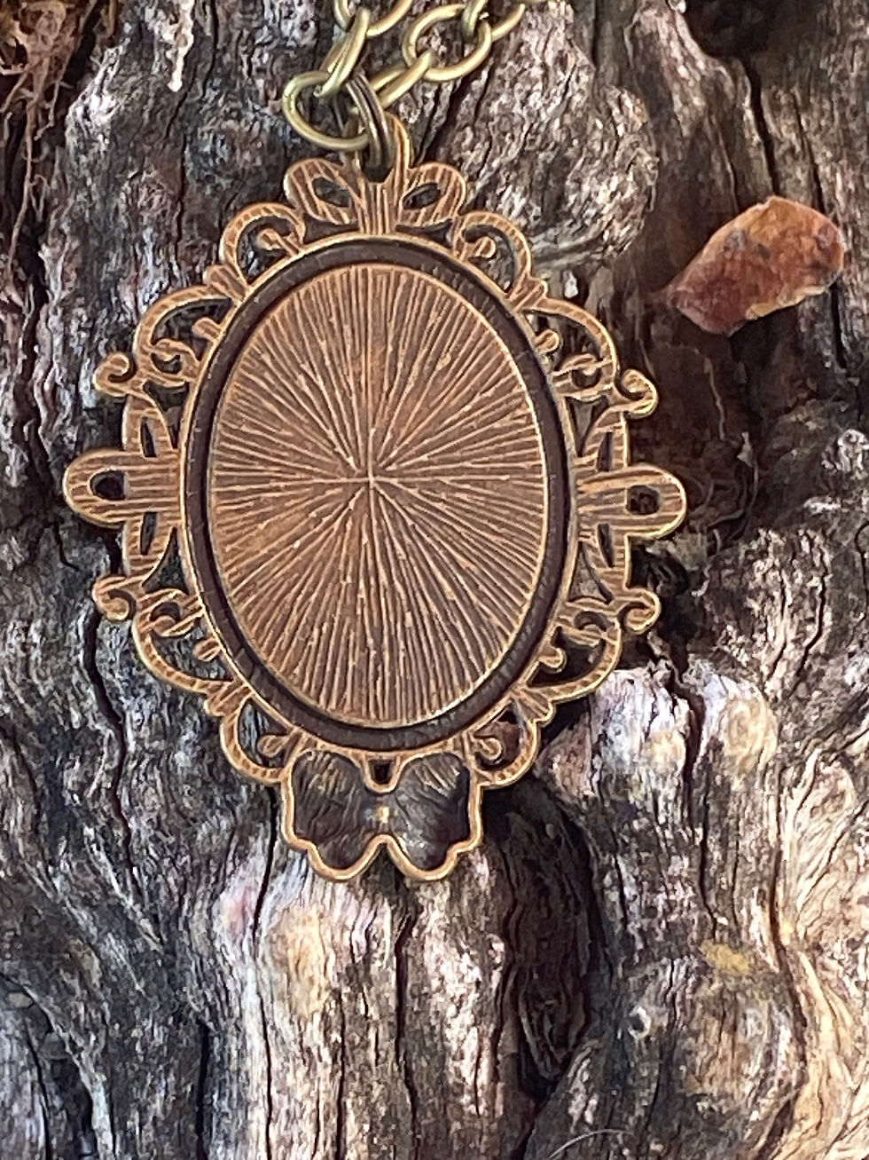 Thumbnail: Back view of the brass pendant showcasing its textured design, emphasizing the pendant's handcrafted detailing.