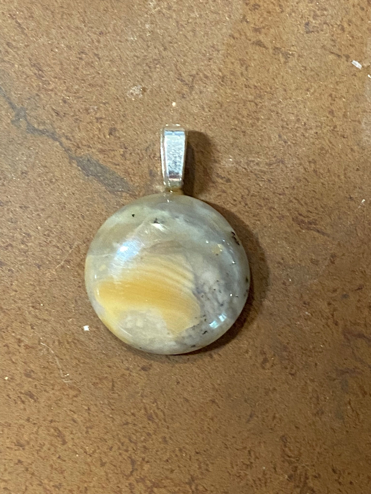Round Butte Creek Agate pendant with a polished finish, set in a simple silver bail.