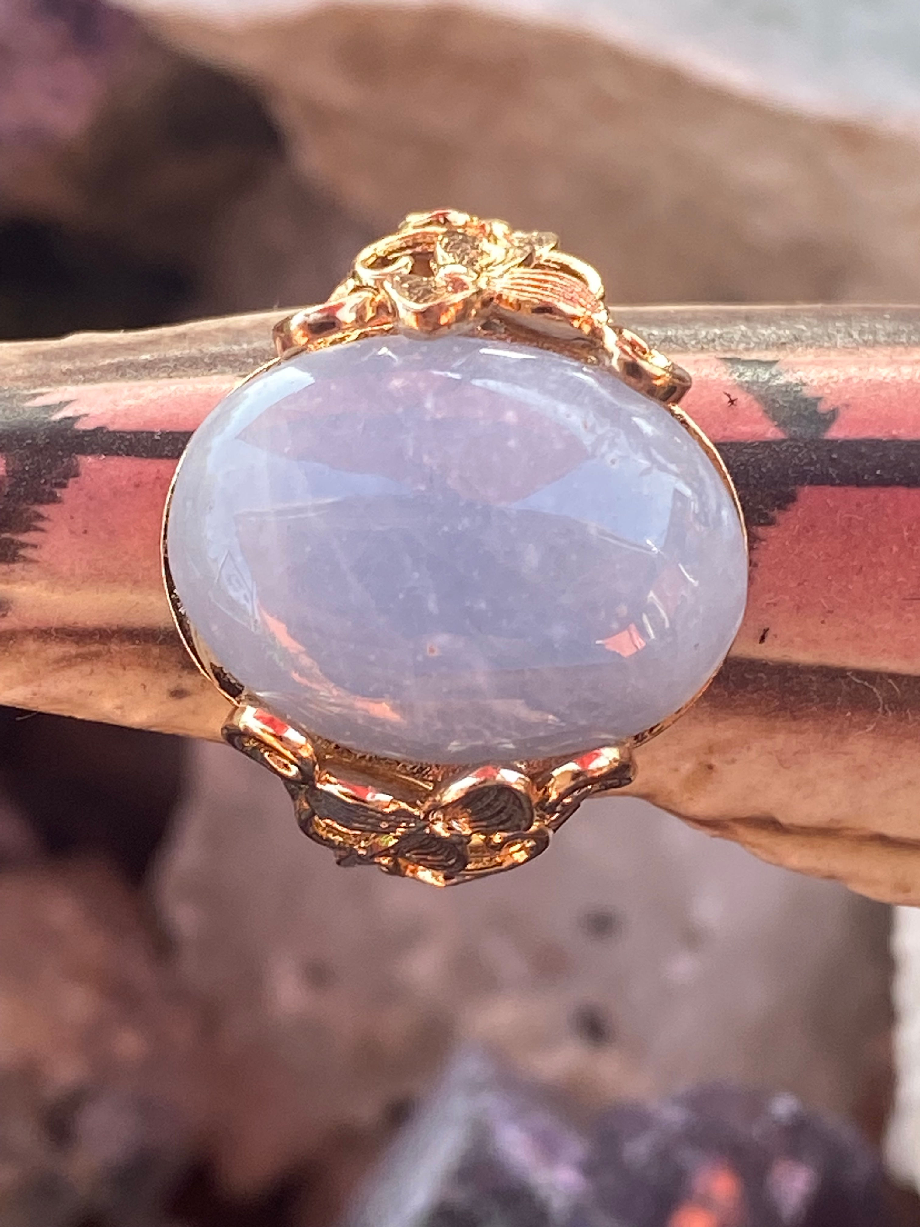 Close-up of aquamarine gemstone set in a gold-plated floral design band