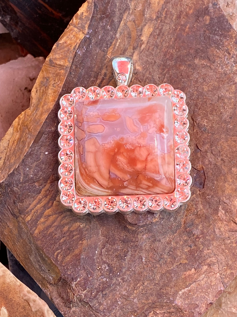 Close-up of the Bubblegum Agate pendant, highlighting its vibrant colors and glossy finish.