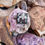 Thumbnail: Utah Chinese Writing Stone pendant displayed with a brass setting, resting on a pinkish rock.