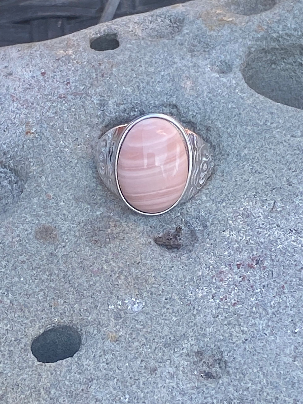 Front-facing view of the Australian Opal ring, emphasizing the gemstone’s striking natural patterns and the ornate silver ban