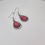Thumbnail: Pair of Thulite teardrop earrings in a sleek metal setting, showcasing their vibrant pink hue.