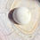 Thumbnail: White Buffalo Turquoise gemstone displayed on a textured stone surface.