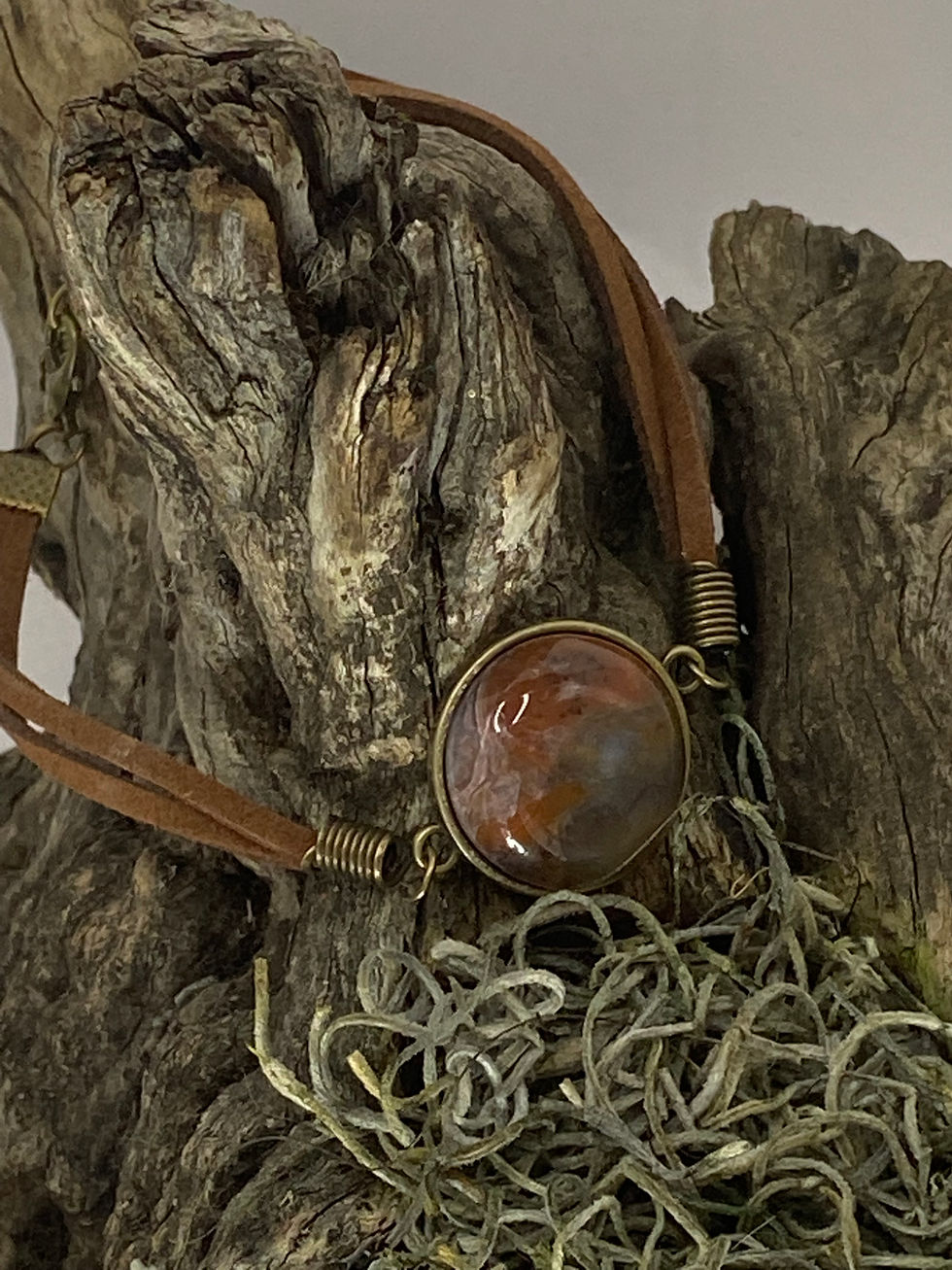 Thumbnail: Full view of Butte Creek Agate leather bracelet resting on moss-covered driftwood.