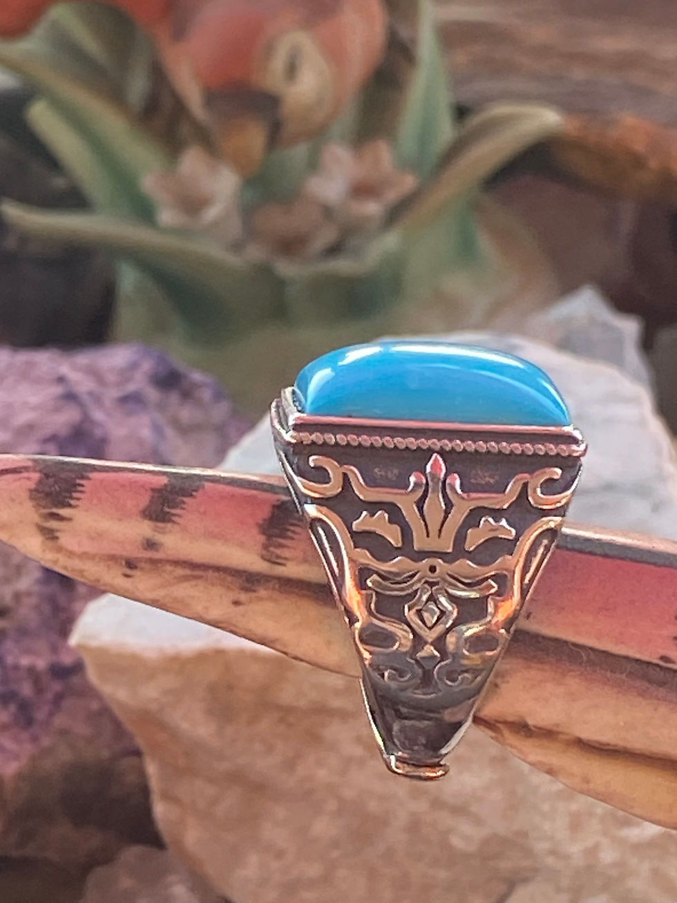 Thumbnail: Side view of an Arizona turquoise ring in sterling silver, featuring ornate patterns and bold blue color.