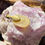 Thumbnail: backside ofCornelian gemstone pendant placed on a textured pink and white quartz surface.