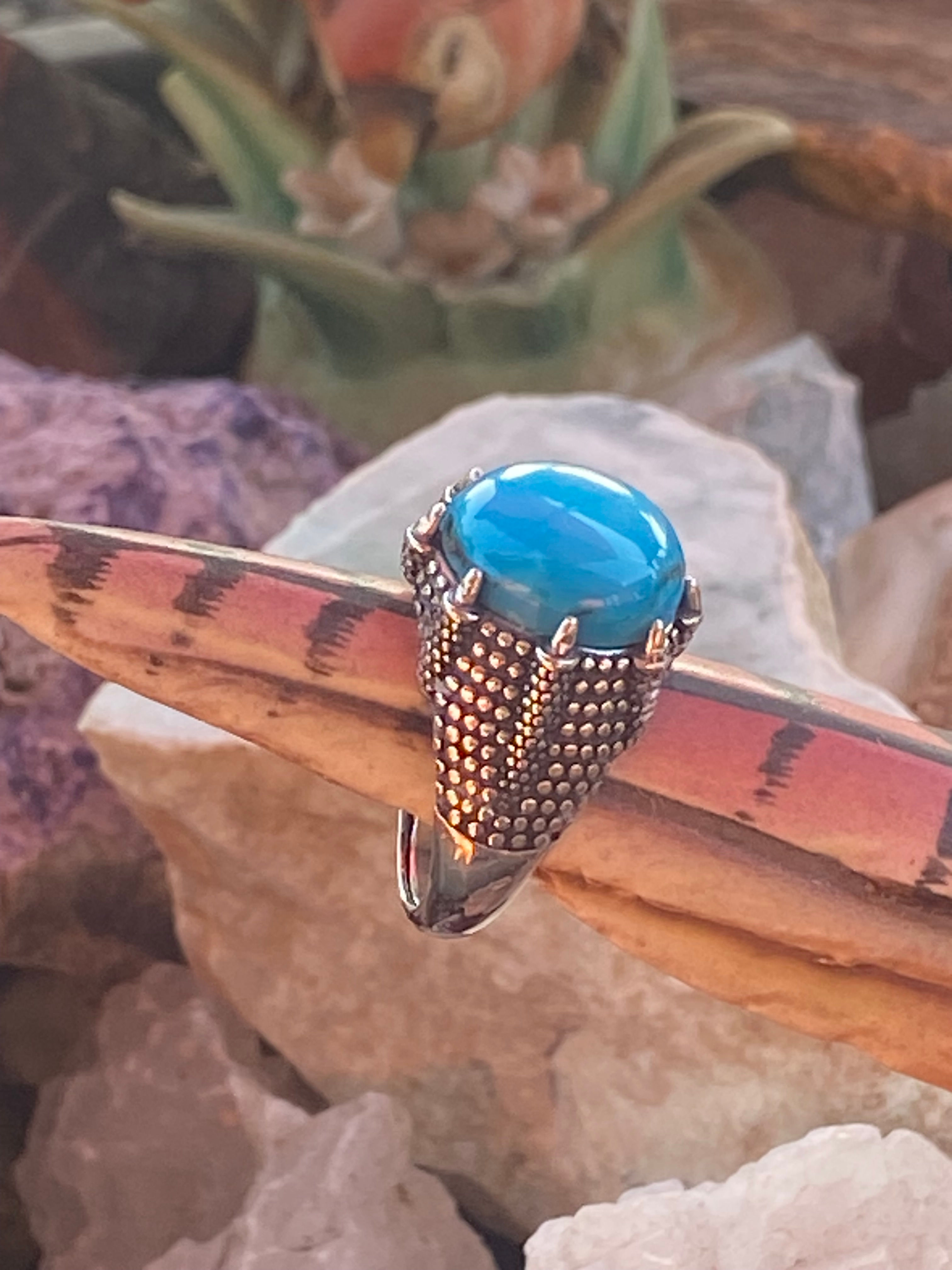 Side profile of an Arizona turquoise ring featuring a bold round cabochon and intricate silver details.