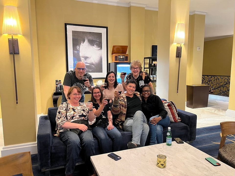 Members of the ScribeConcepts team sit on a couch after meeting for the first time.