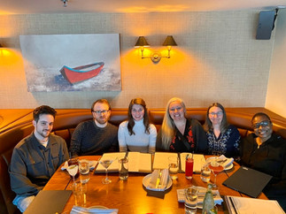 John Coakley, Tyler Combelic, Natalie Rebentisch, Lauren Ramsden, Diane DeMarco, and Cheryl Golding sit at a table for a nice dinner.
