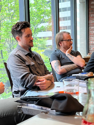 John Coakley and Tyler Combelic listen in on a meeting.
