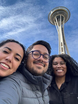 Teresa Hamilton, Ben Baio, and Aliyah Reese pose for a photo in front of the Space Needle in Seattle.