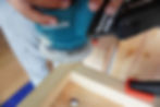 using a random orbital sander to make indents in the wooden frame