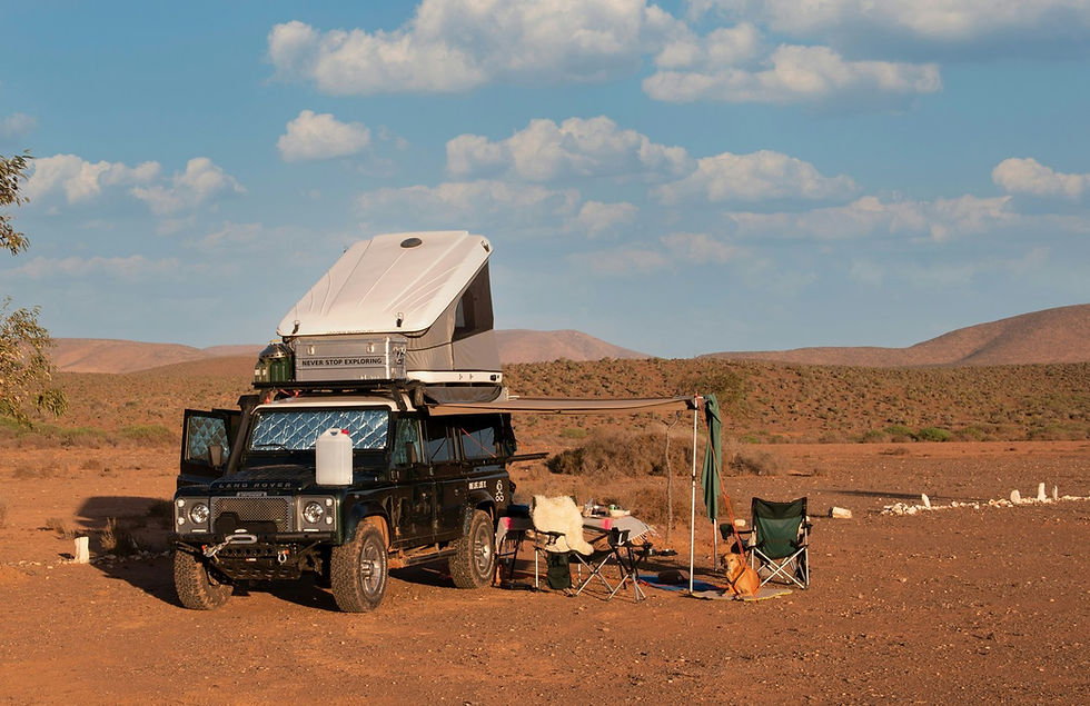 A land rover-based camper parked in the desert