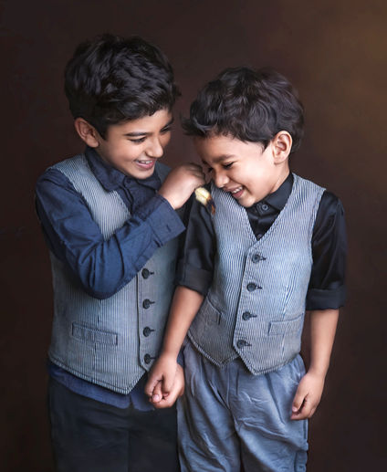 Happy siblings with family during a professional family photoshoot in Pune