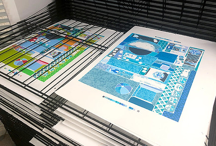 Copies of David Burrow’s silk screen prints on paper stored in metal art drying racks