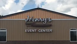 Lighted sign for Henry's Event Center on the building front, with elegant script and clear lettering.