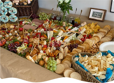 A colourful, tasty looking graze table by Perfect Platters by Julie is set up in a rustic, appealling fashion