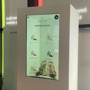 White transparent LCD in portrait showing retail type display with high heel shows inside