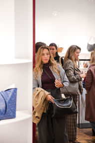 Candid interaction between guests at luxury brand activation event in Madrid